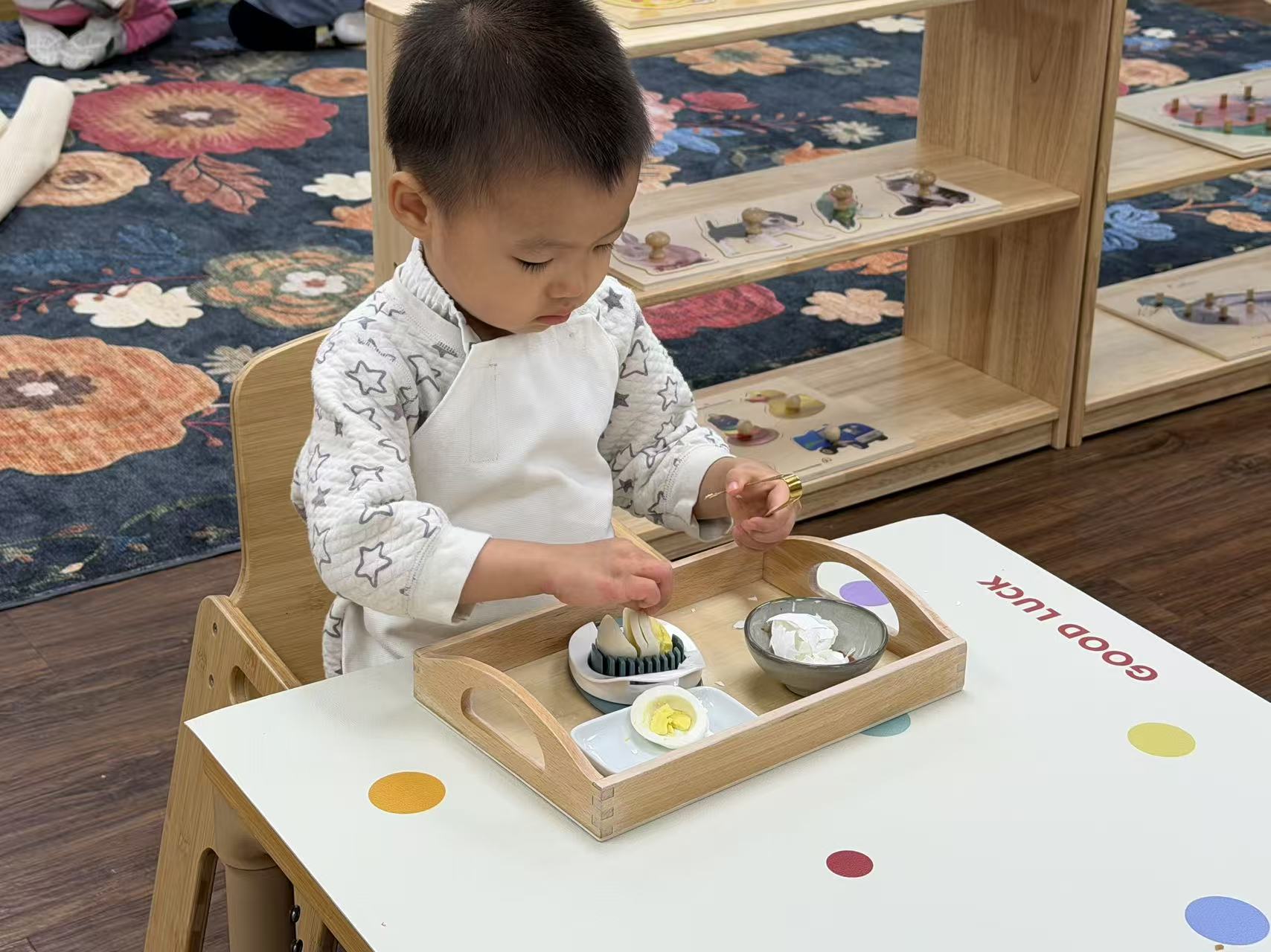 a child peeling and slicing a hard-boiled egg