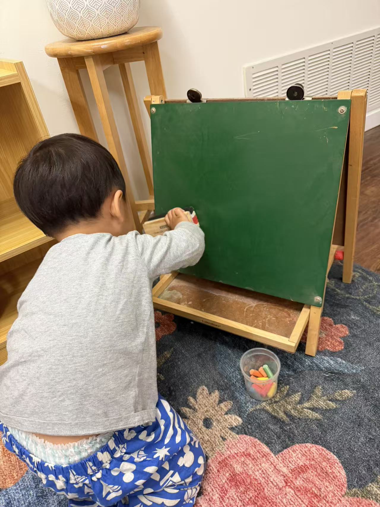 a child erasing a chalkboard